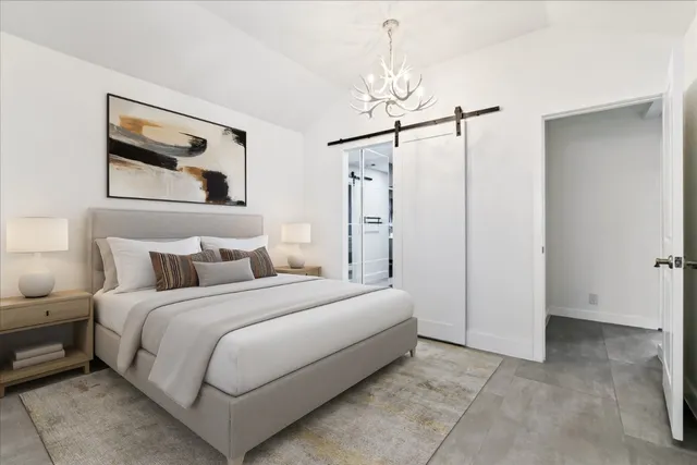 a bedroom with a bed and a mirror