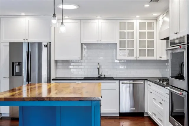 a kitchen with stainless steel appliances granite countertop a sink and cabinets
