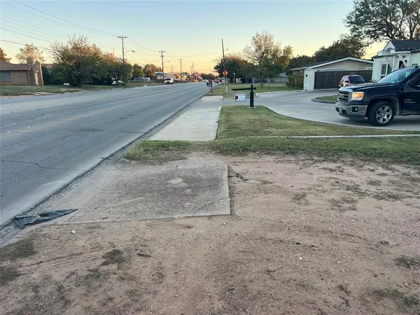 a view of street with parked cars