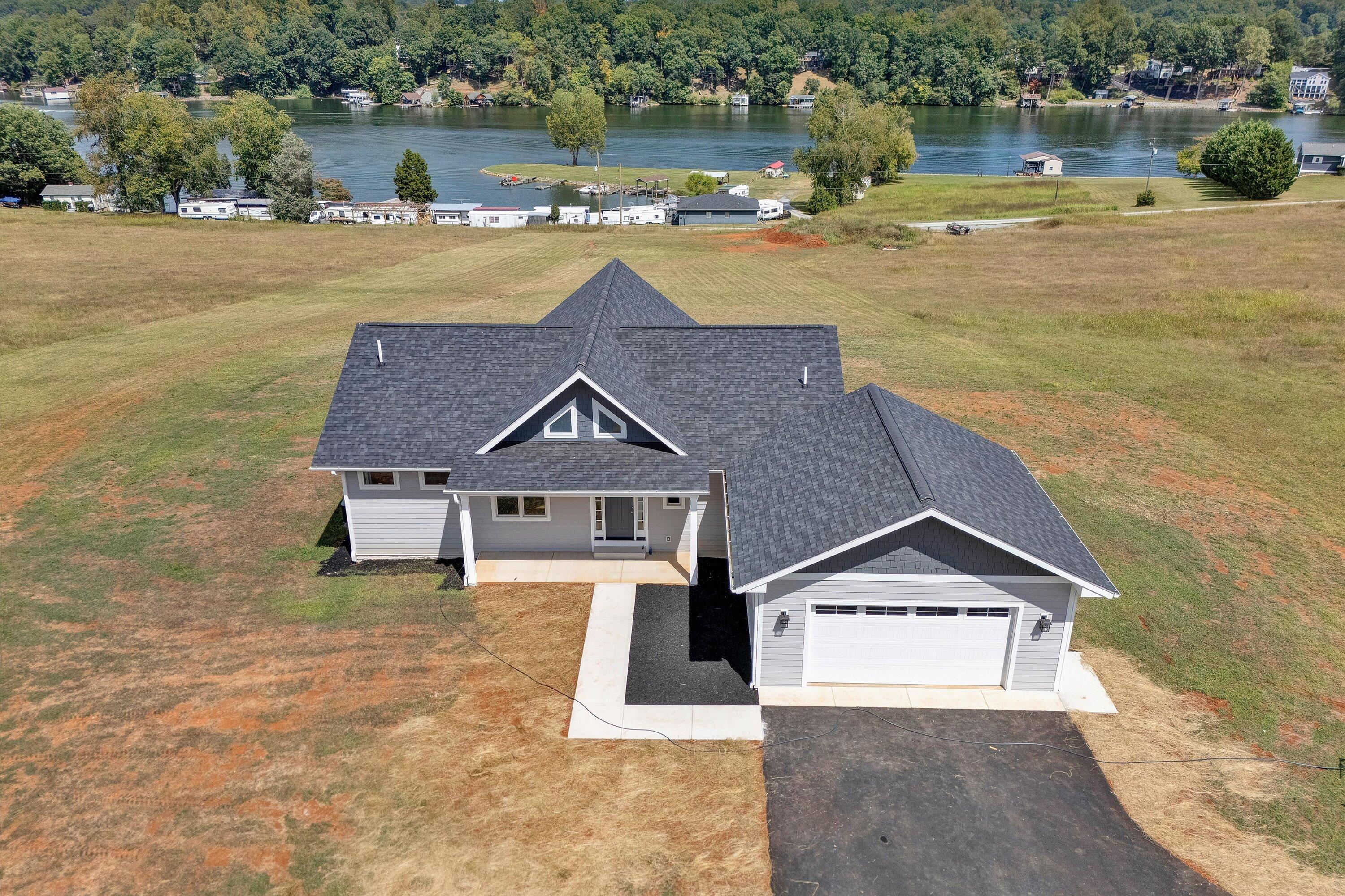 7012 Horseshoe Bend Road Goodview, VA 24095 - Photo 3 of 56 an aerial view of a house with a yard and lake view