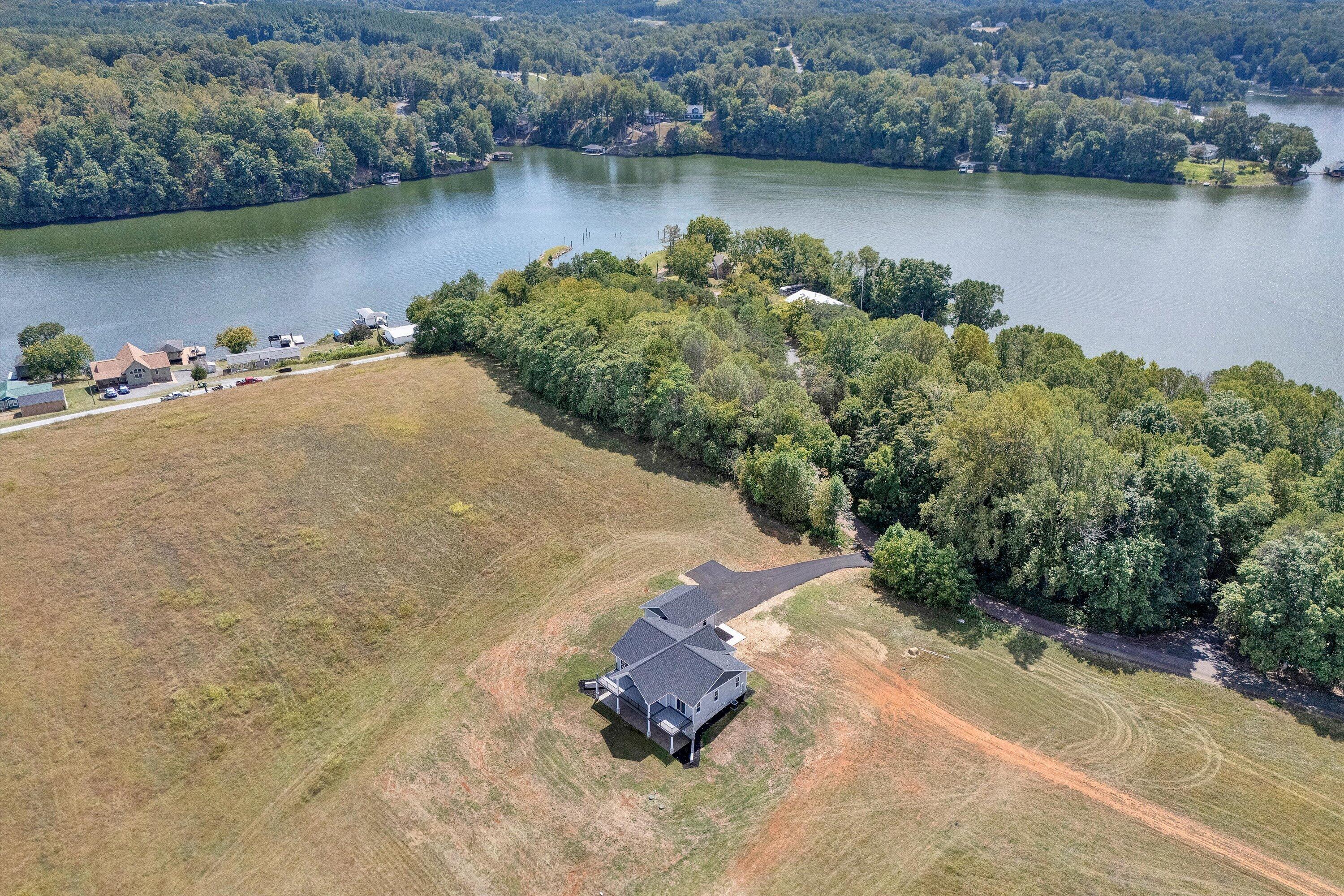7012 Horseshoe Bend Road Goodview, VA 24095 - Photo 50 of 56 an aerial view of a house with a yard and a lake view