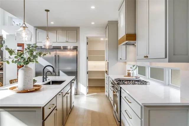 a view of a dining room with furniture and a chandelier fan