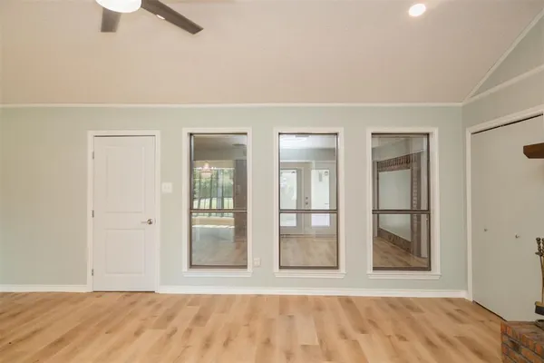an empty room with windows and closet