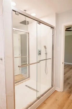 a bathroom with a glass shower door