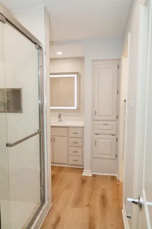 a view of a kitchen with white cabinets and refrigerator