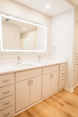 a bathroom with a sink vanity and mirror