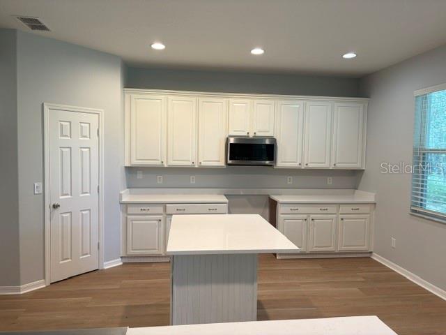 1885 Scrub Jay Road Apopka, FL 32703 - Photo 5 of 29 a kitchen with kitchen island granite countertop white cabinets and stainless steel appliances