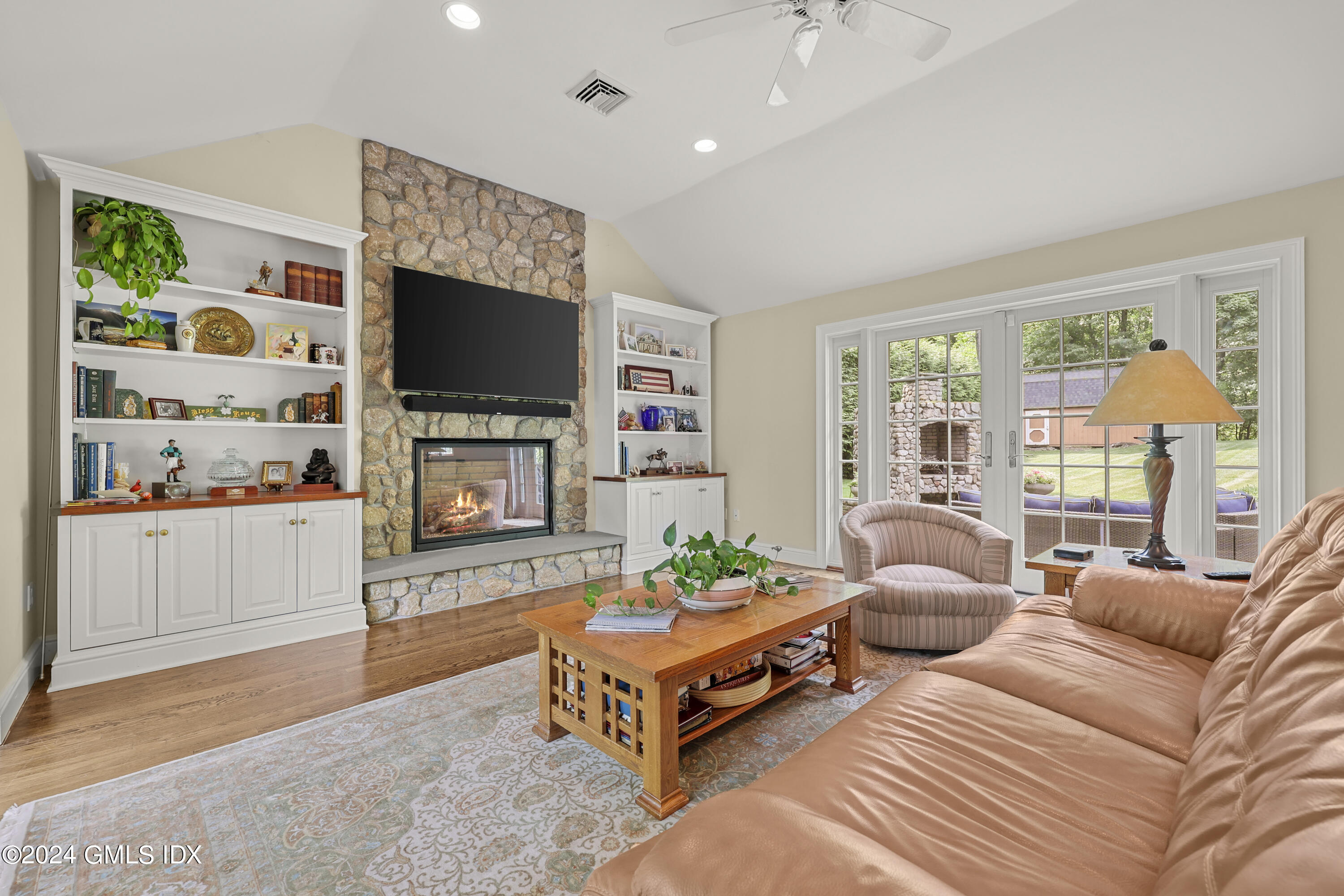 56 Flint Rock Road Stamford, CT 06903 - Photo 11 of 28 a living room with fireplace furniture and a flat screen tv