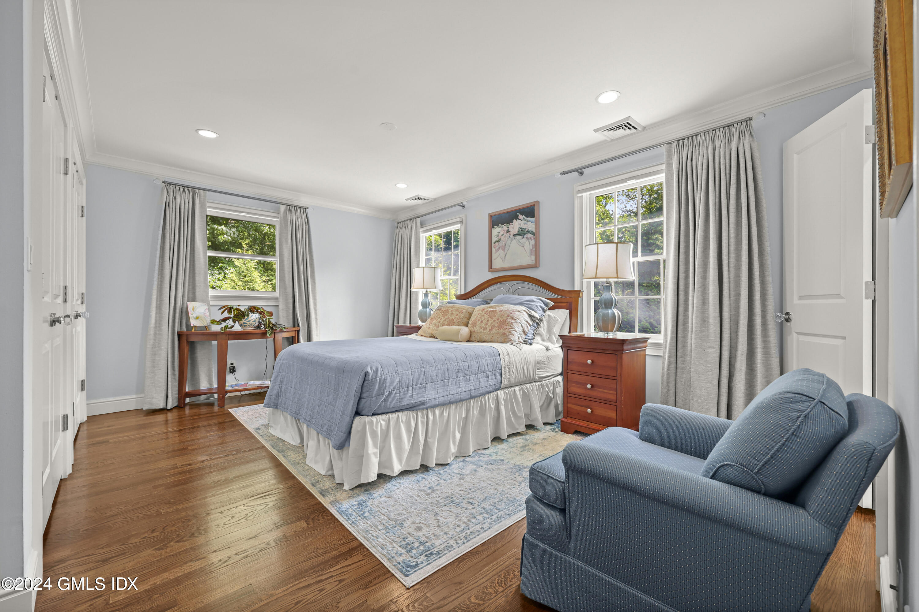 56 Flint Rock Road Stamford, CT 06903 - Photo 18 of 28 a bedroom with a bed and wooden floor