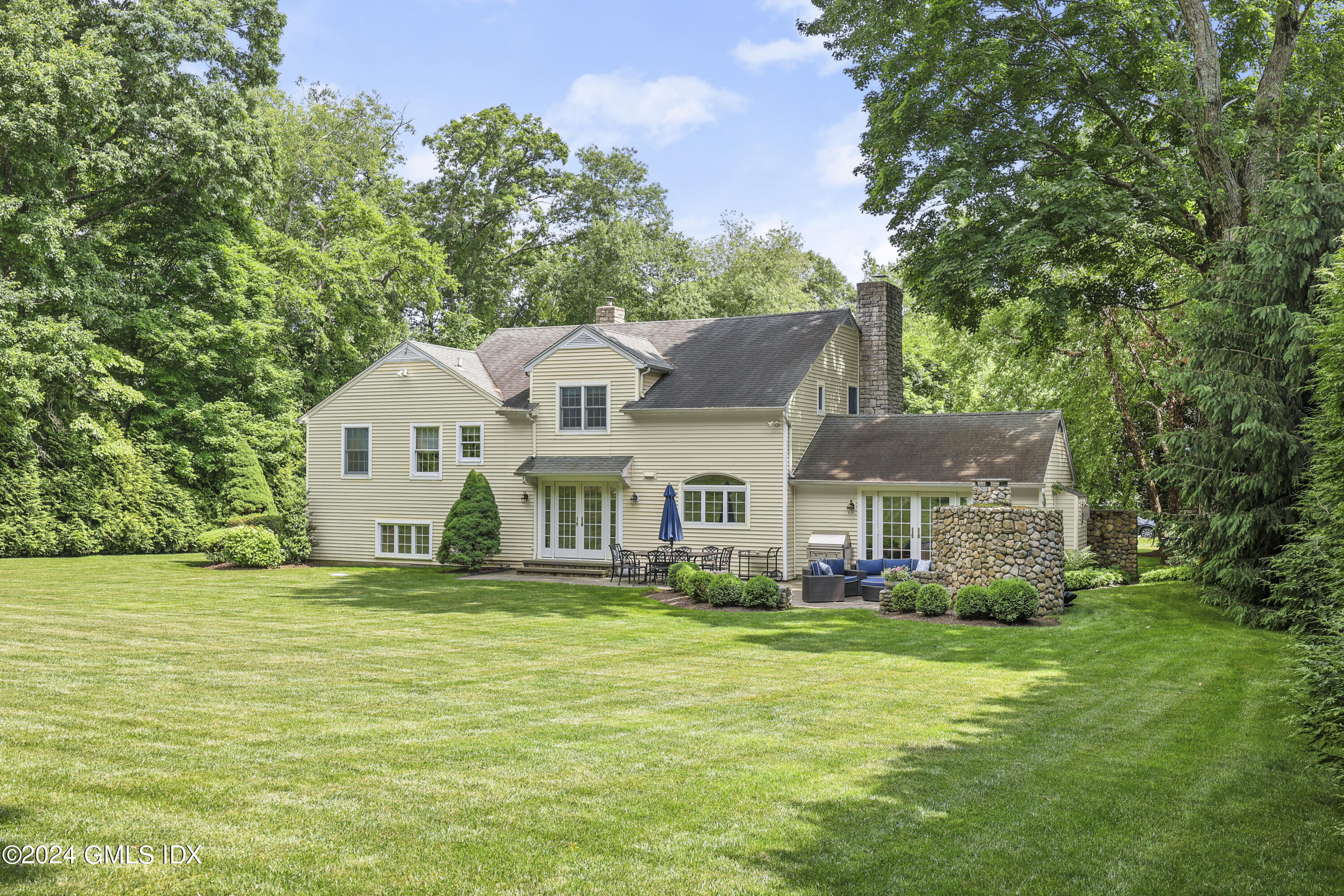 56 Flint Rock Road Stamford, CT 06903 - Photo 22 of 28 a front view of a house with a garden