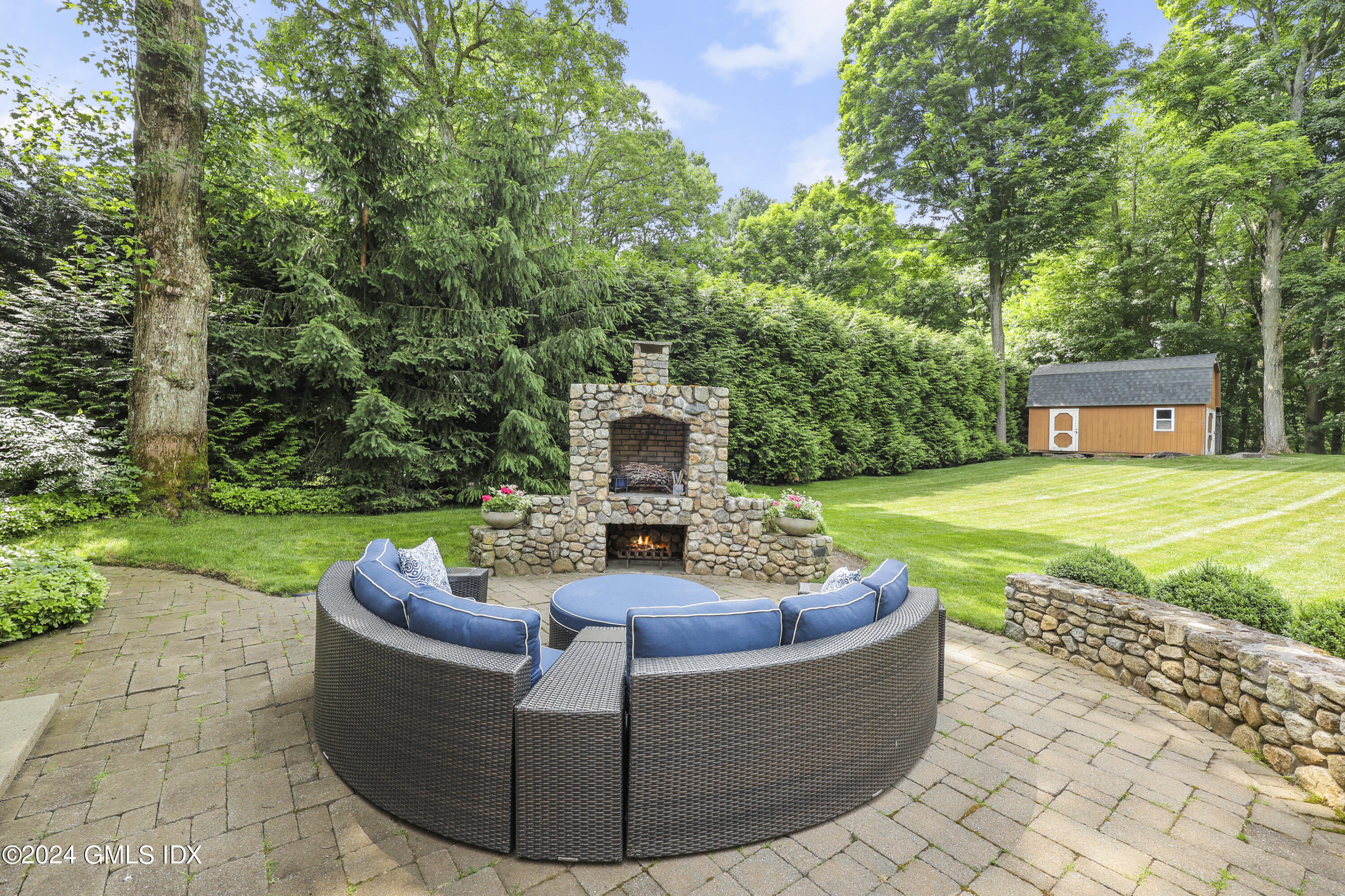 56 Flint Rock Road Stamford, CT 06903 - Photo 23 of 28 a view of a couches in a patio with a yard