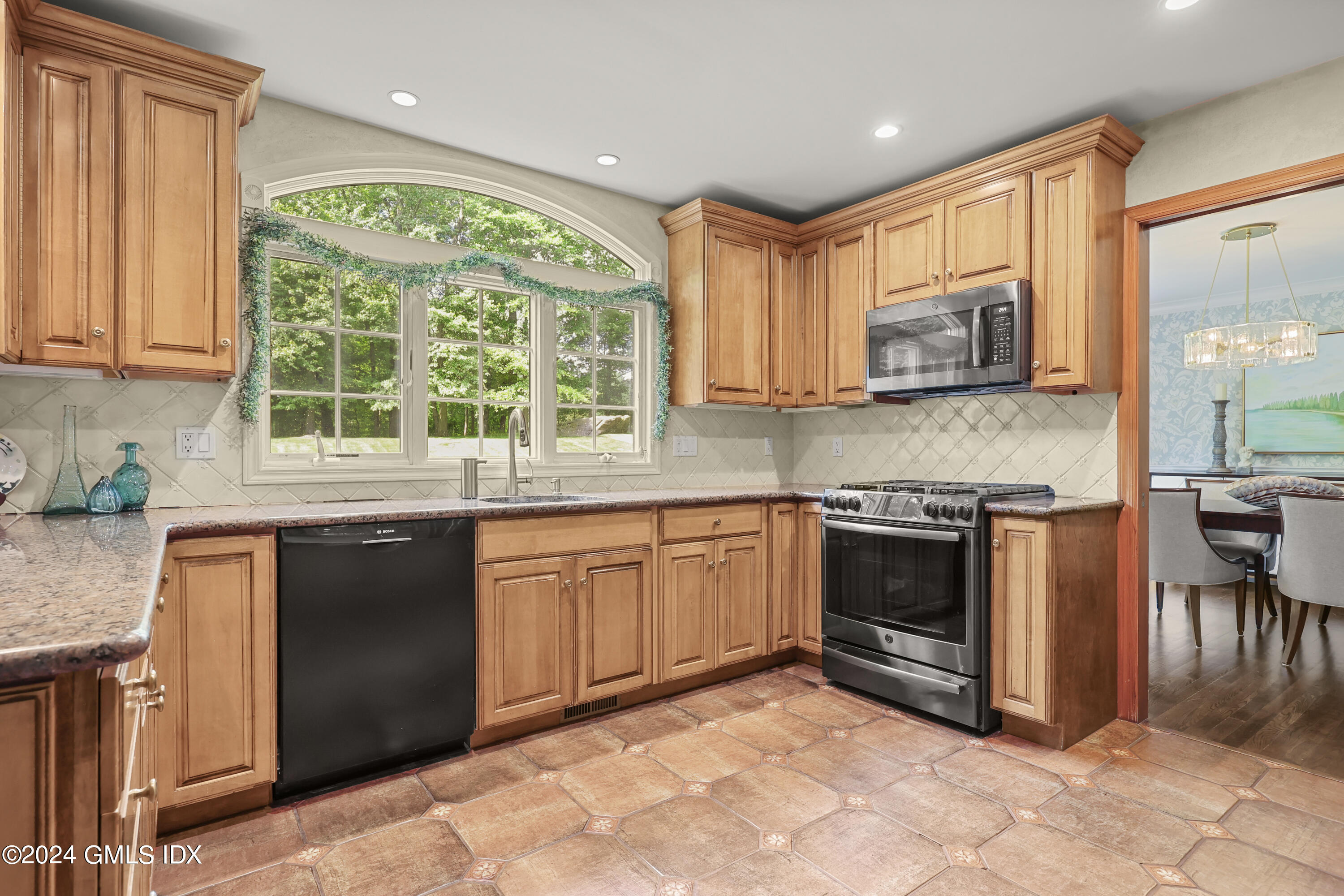56 Flint Rock Road Stamford, CT 06903 - Photo 9 of 28 a kitchen with stainless steel appliances granite countertop a stove sink and cabinets