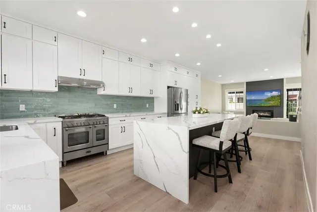 a kitchen with white cabinets and white appliances