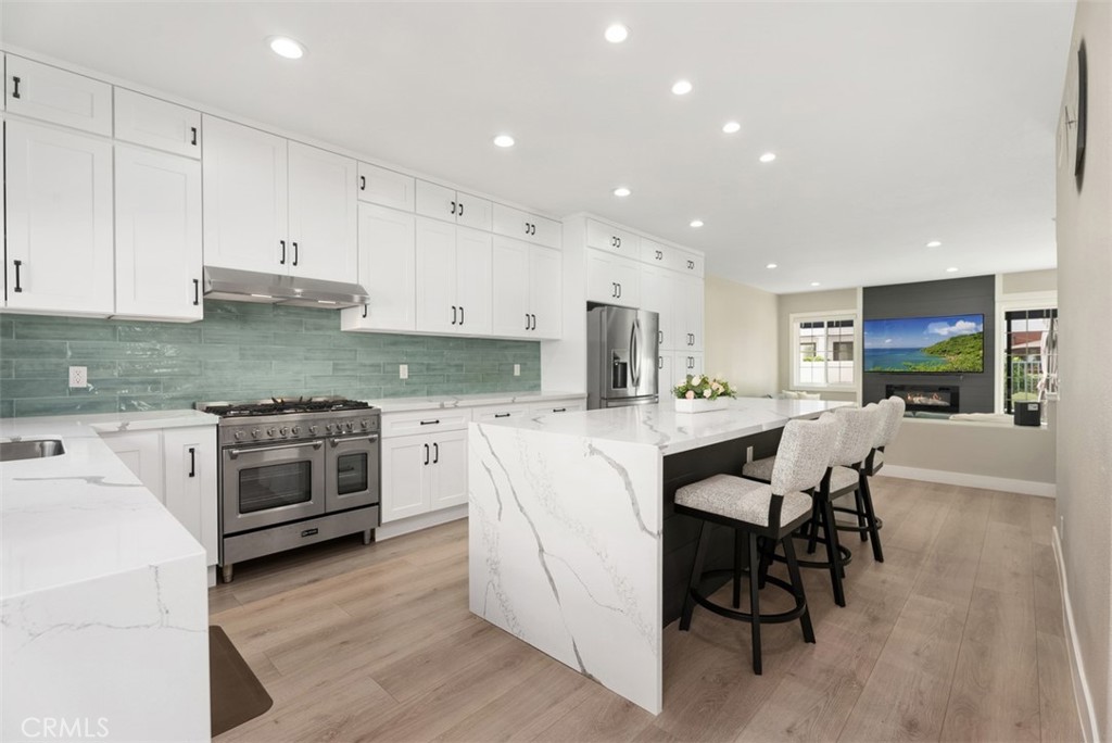 19502 Ranch Lane, Unit 112 Huntington Beach, CA 92648 - Photo 12 of 45 a kitchen with white cabinets and white appliances