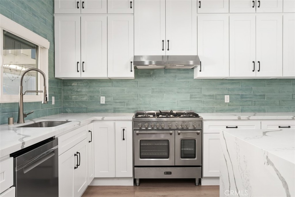 19502 Ranch Lane, Unit 112 Huntington Beach, CA 92648 - Photo 13 of 45 a kitchen with cabinets appliances and a sink