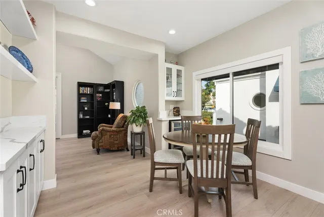 a dining room with furniture and wooden floor
