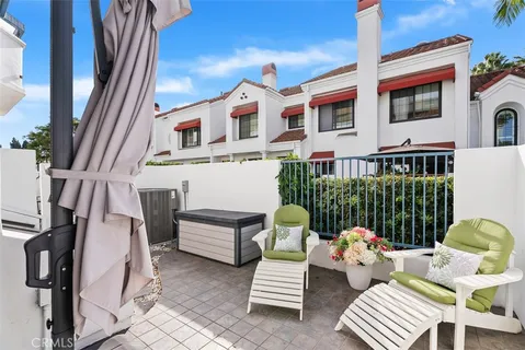 a front view of a house with outdoor seating