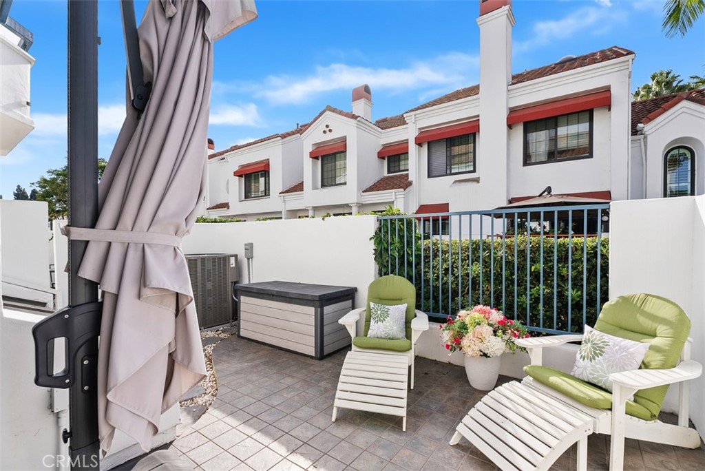 19502 Ranch Lane, Unit 112 Huntington Beach, CA 92648 - Photo 19 of 45 a front view of a house with outdoor seating