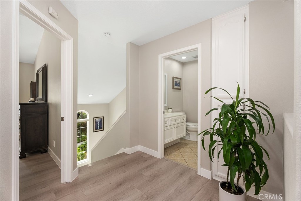 19502 Ranch Lane, Unit 112 Huntington Beach, CA 92648 - Photo 23 of 45 a view of a hallway with wooden floor and a potted plant
