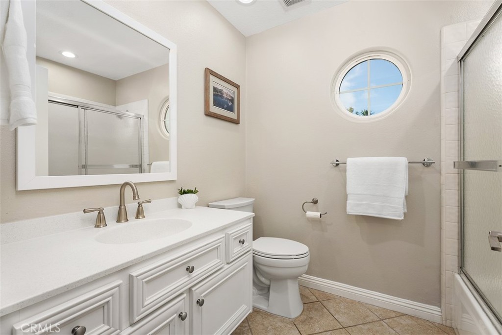 19502 Ranch Lane, Unit 112 Huntington Beach, CA 92648 - Photo 24 of 45 a bathroom with a toilet sink and mirror