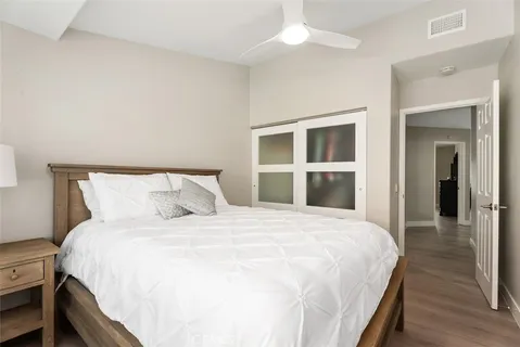 a large bed sitting in a bedroom and a large window