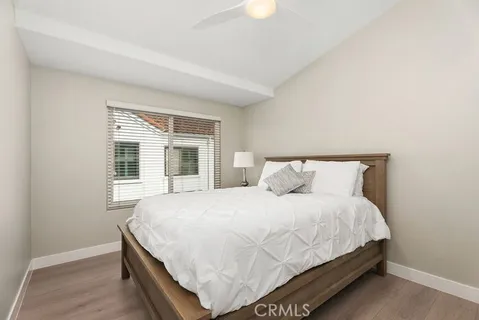 a large bed sitting in a bedroom next to a window and a dresser