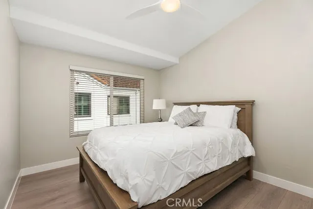 a large bed sitting in a bedroom next to a window and a dresser