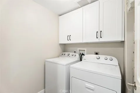 a view of storage and utility room with washer and dryer