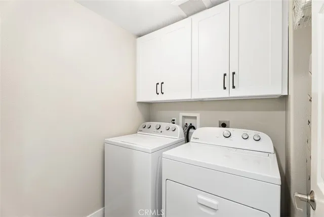 a view of storage and utility room with washer and dryer