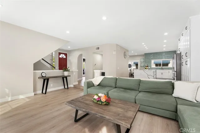 a living room with furniture and a potted plant