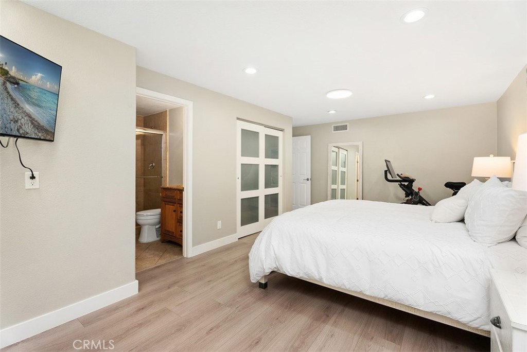 19502 Ranch Lane, Unit 112 Huntington Beach, CA 92648 - Photo 31 of 45 a bedroom with a bed and a large window