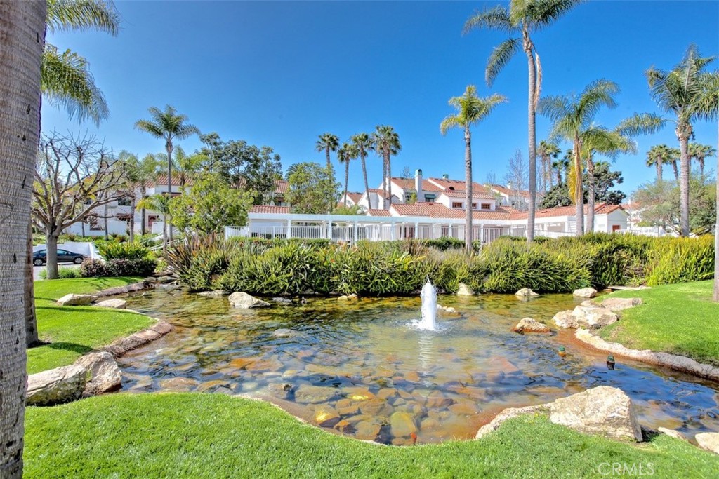 19502 Ranch Lane, Unit 112 Huntington Beach, CA 92648 - Photo 39 of 45 a view of a fountain in front of a house with a yard