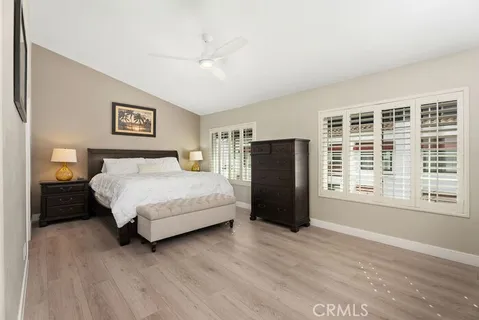 a spacious bedroom with a bed dresser and a window