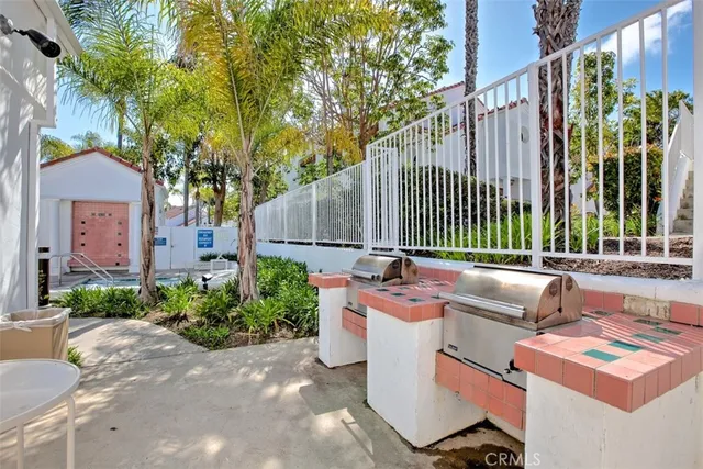 a view of a patio with couches table and chairs and potted plants