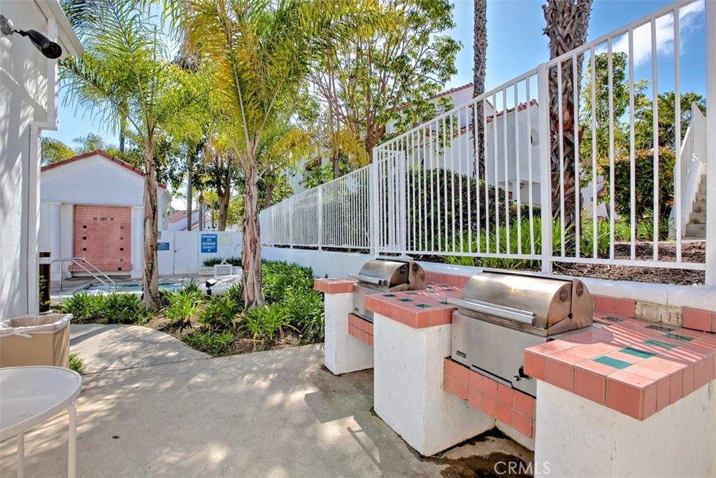 19502 Ranch Lane, Unit 112 Huntington Beach, CA 92648 - Photo 41 of 45 a view of a patio with couches table and chairs and potted plants
