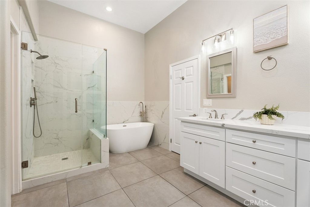 19502 Ranch Lane, Unit 112 Huntington Beach, CA 92648 - Photo 5 of 45 a bathroom with a shower sink and mirror