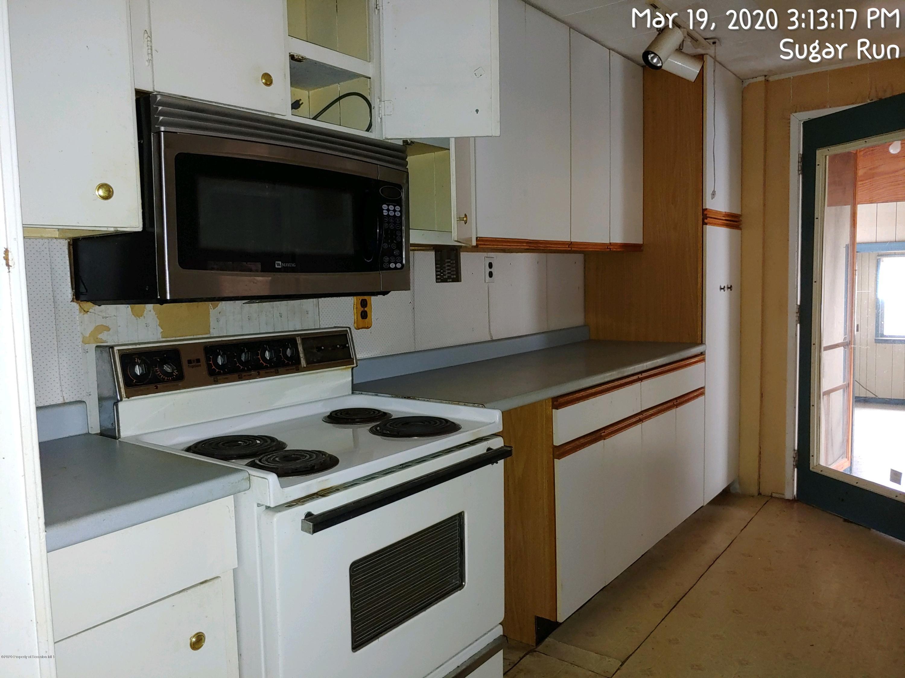 437 Dietz Road Sugar Run, PA 18846 - Photo 8 of 20 a kitchen with cabinets and appliances