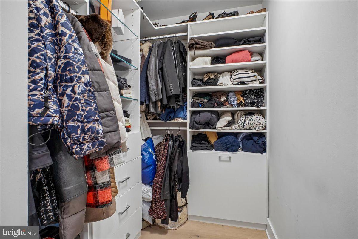 1211 Van Street Southeast, Unit 403 Washington, DC 20003 - Photo 15 of 21 a view of walk in closet with clothes and shoes