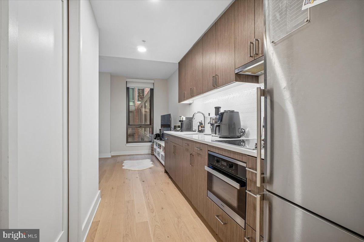 1211 Van Street Southeast, Unit 403 Washington, DC 20003 - Photo 6 of 21 a kitchen with stainless steel appliances granite countertop a refrigerator and a sink