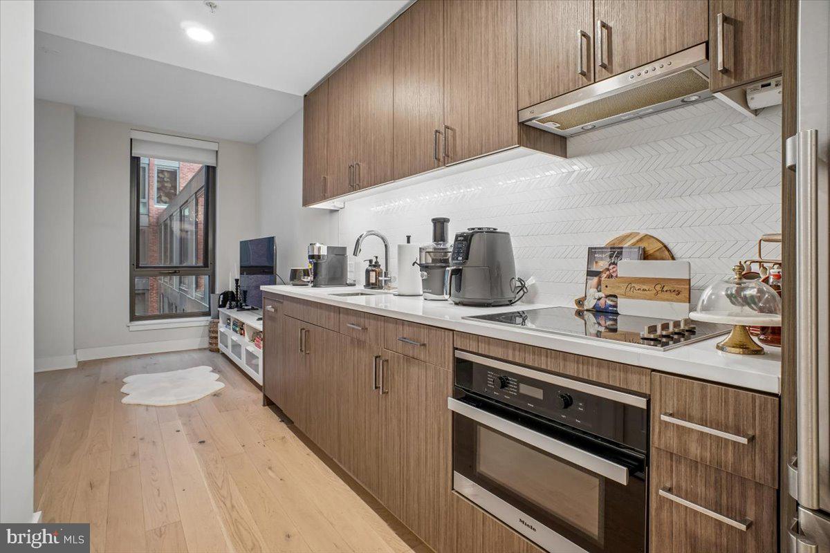 1211 Van Street Southeast, Unit 403 Washington, DC 20003 - Photo 7 of 21 a kitchen with a sink stove and cabinets