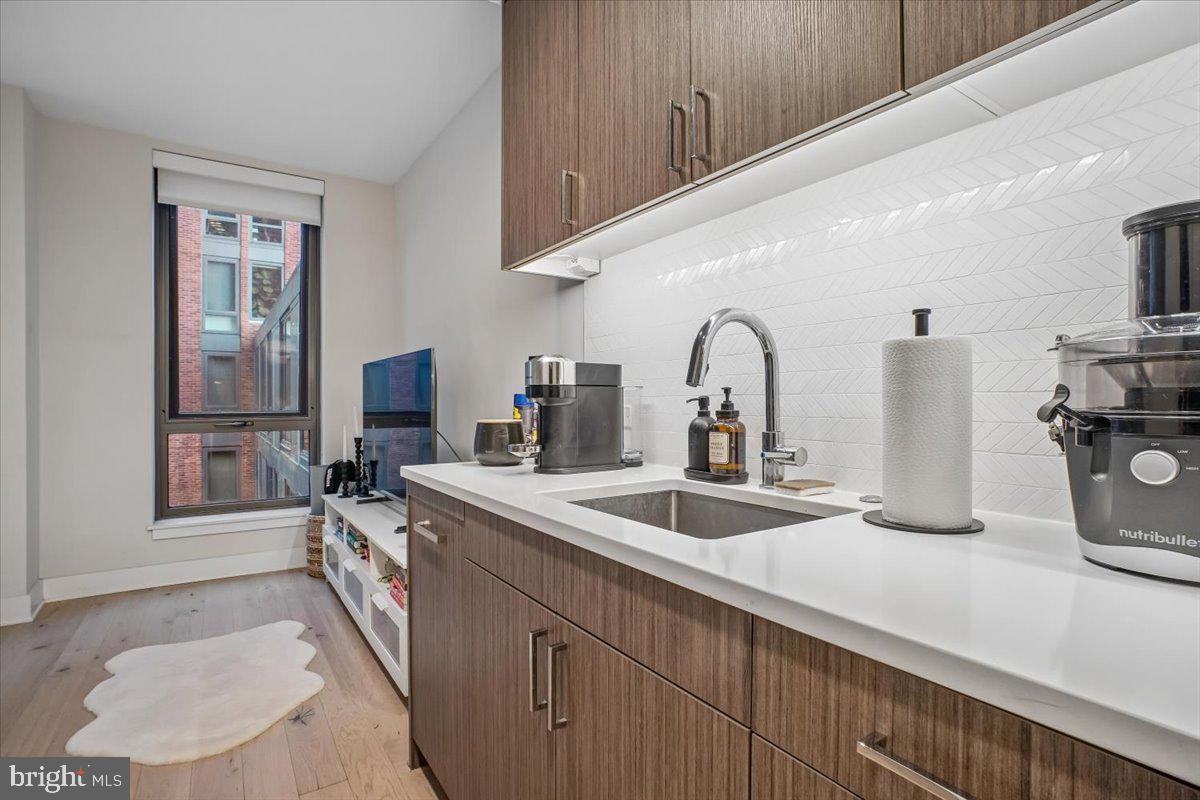 1211 Van Street Southeast, Unit 403 Washington, DC 20003 - Photo 8 of 21 a kitchen with a sink and a refrigerator