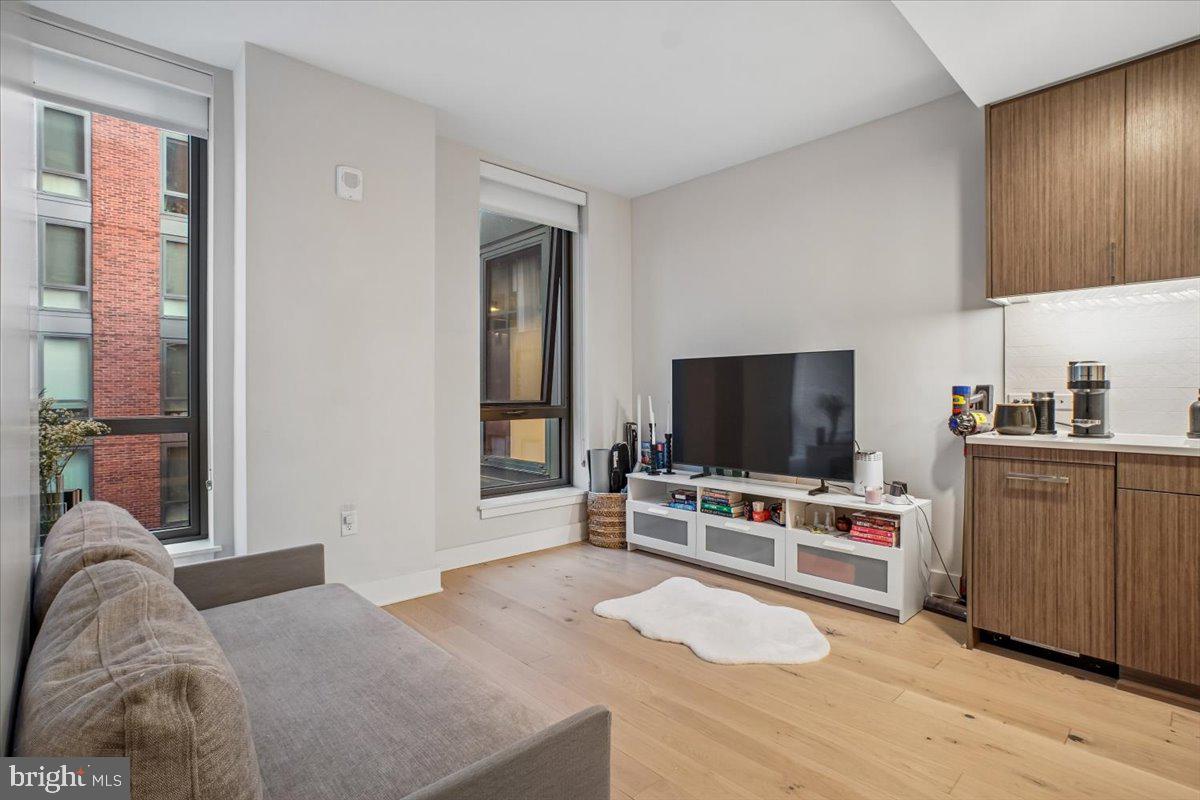 1211 Van Street Southeast, Unit 403 Washington, DC 20003 - Photo 10 of 21 a bedroom with furniture and a flat screen tv