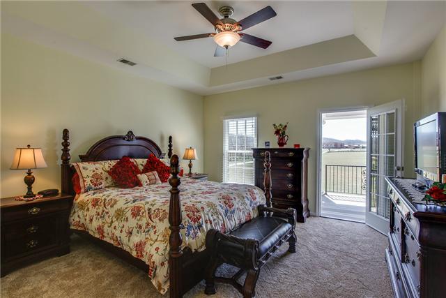 6288 Arno Road Franklin, TN 37064 - Photo 11 of 20 a bedroom with a bed and a chandelier
