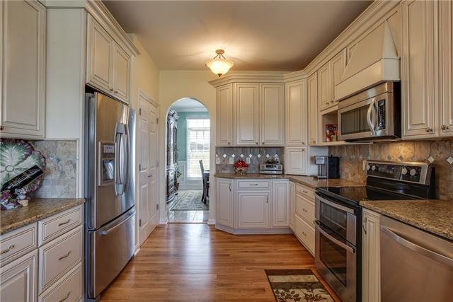 6288 Arno Road Franklin, TN 37064 - Photo 8 of 20 a kitchen with stainless steel appliances granite countertop a refrigerator a stove top oven a sink and dishwasher