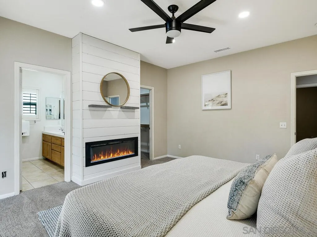 16304 Dartolo Road Ramona, CA 92065 - Photo 19 of 36 a bedroom with a bed and a fireplace