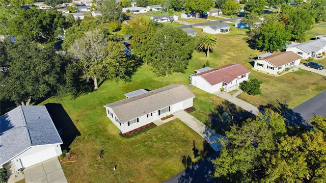 an aerial view of a house with yard swimming pool and outdoor seating