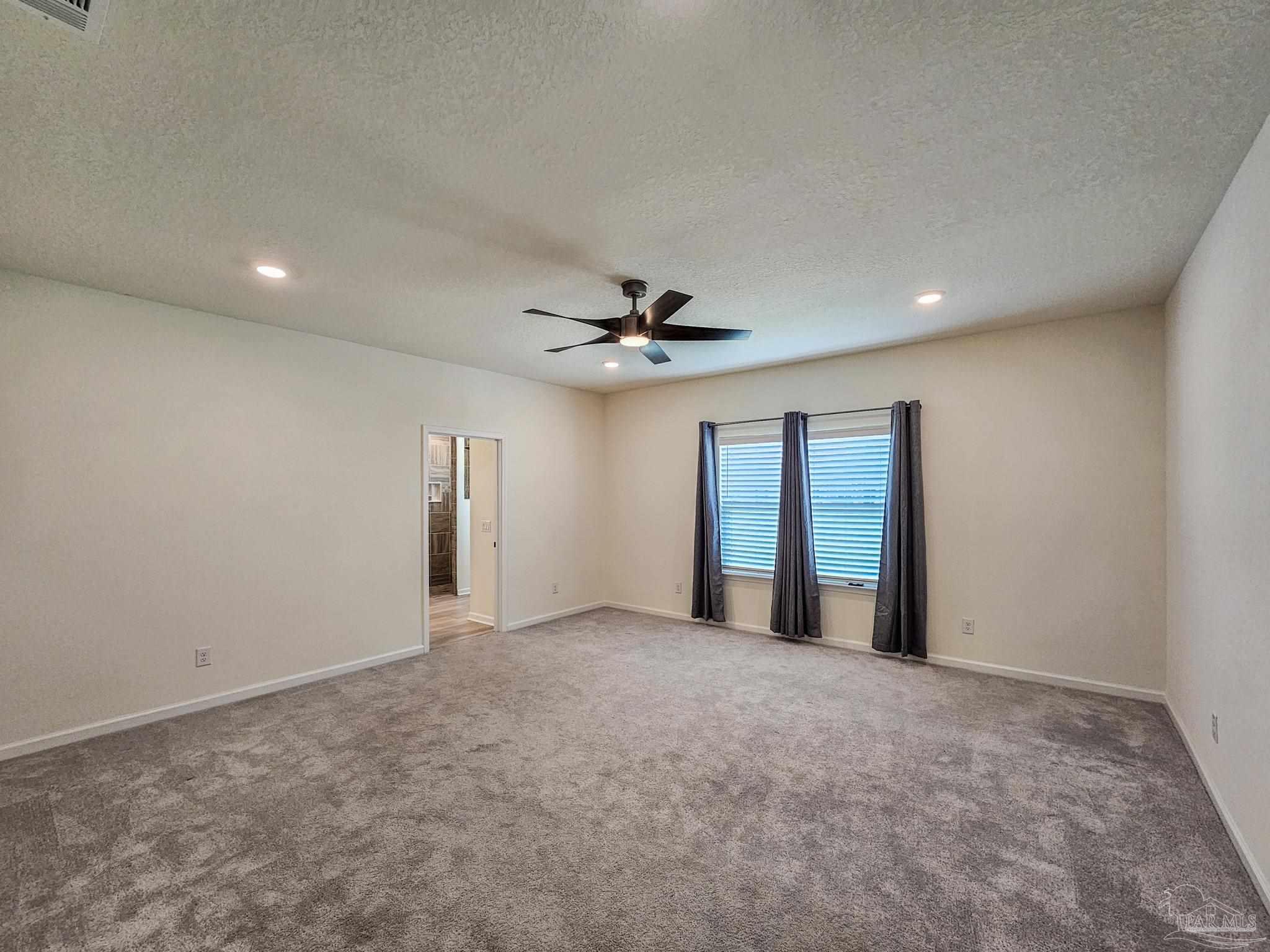 4149 Upper Walk Lane Milton, FL 32583 - Photo 11 of 43 an empty room with windows and fan
