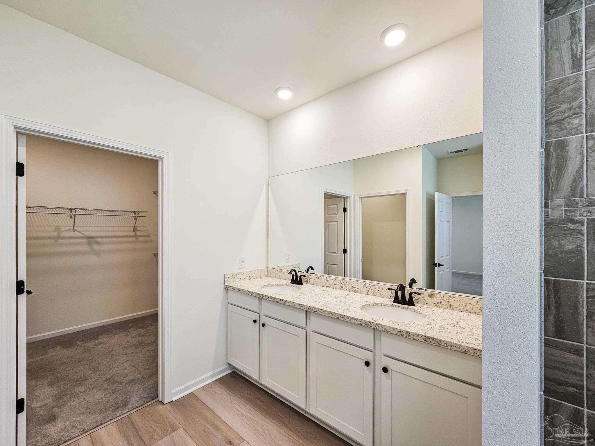 4149 Upper Walk Lane Milton, FL 32583 - Photo 13 of 43 a bathroom with a double vanity sink and mirror
