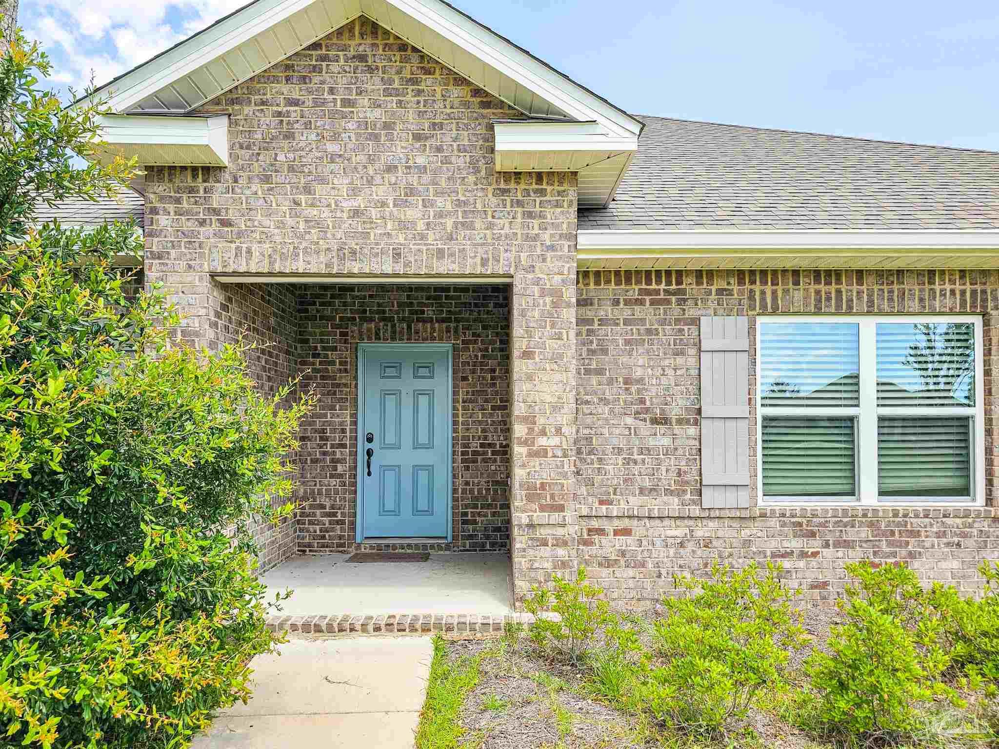 4149 Upper Walk Lane Milton, FL 32583 - Photo 2 of 43 a front view of a house with a garden