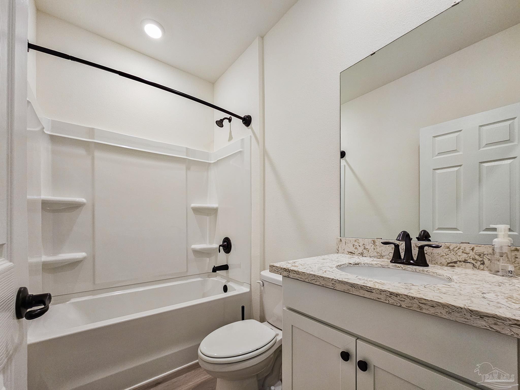 4149 Upper Walk Lane Milton, FL 32583 - Photo 22 of 43 a bathroom with a granite countertop bathtub shower sink vanity mirror and toilet